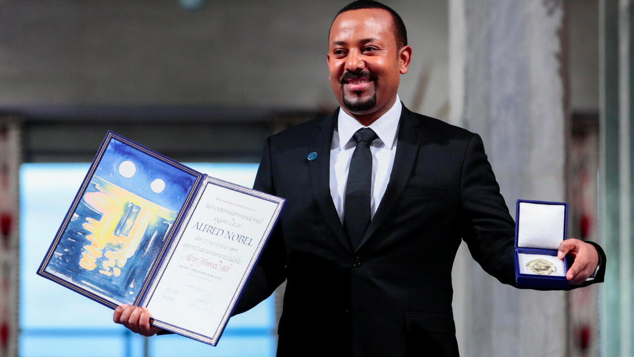 A person in a suit holding a book
AI-generated content may be incorrect.