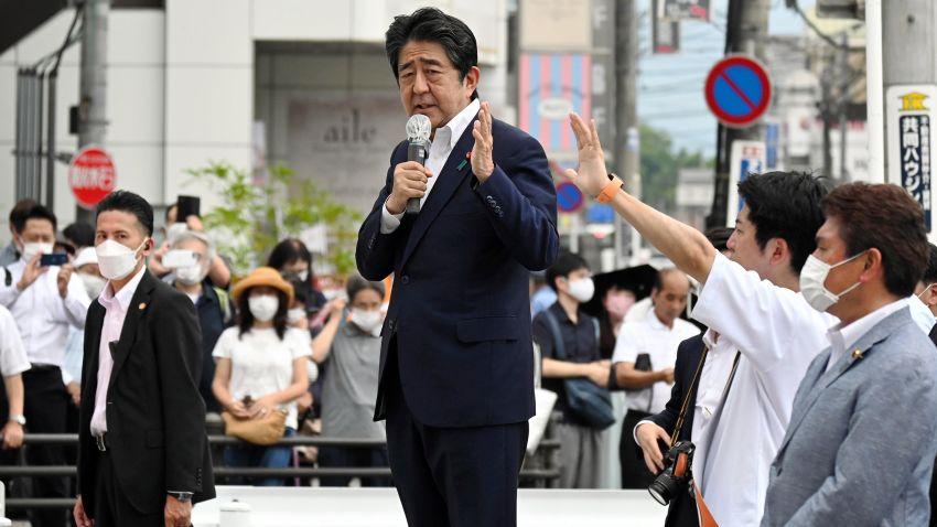 A person in a suit holding a microphone
AI-generated content may be incorrect.