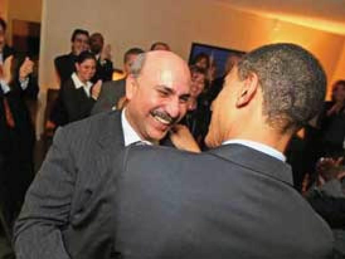 A person in a suit hugging another person
AI-generated content may be incorrect.