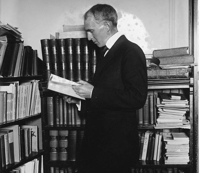 A person reading a book in front of a bookshelf
AI-generated content may be incorrect.
