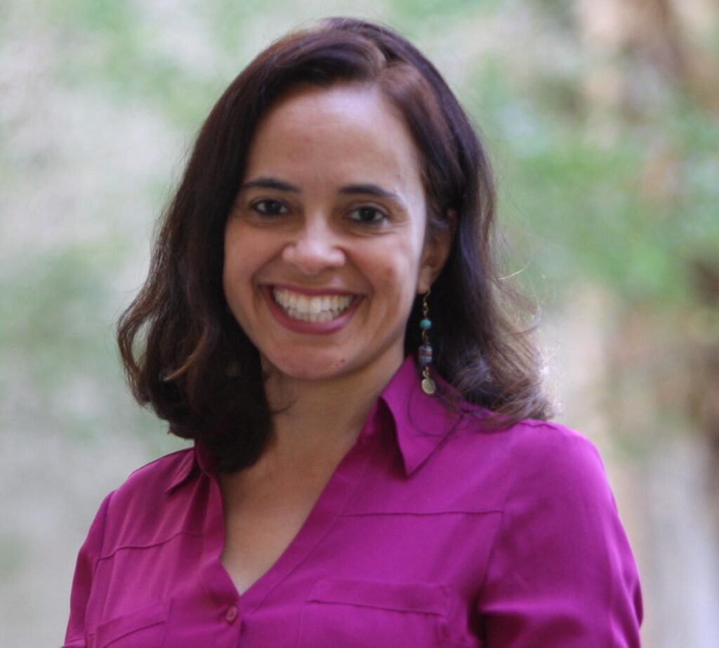 A person smiling at camera AI-generated content may be incorrect.