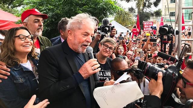 A person speaking into a microphone with a crowd of people
AI-generated content may be incorrect.