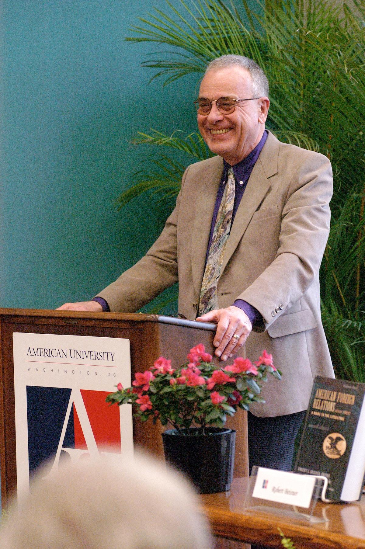 A person standing at a podium
AI-generated content may be incorrect.