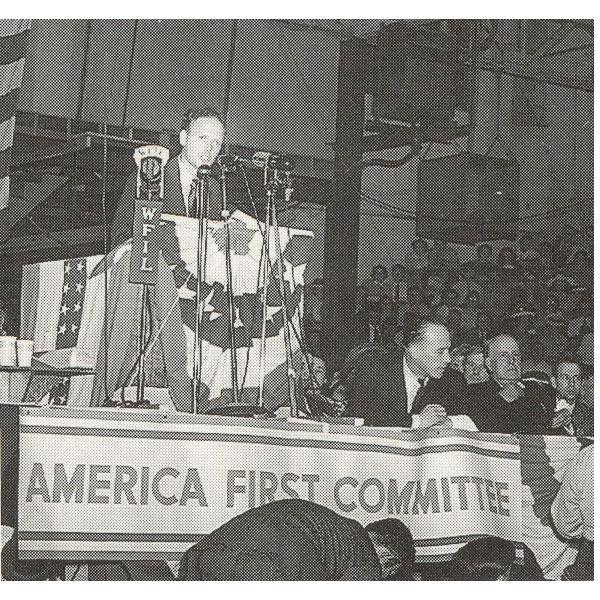 A person standing at a podium with microphones AI-generated content may be incorrect.