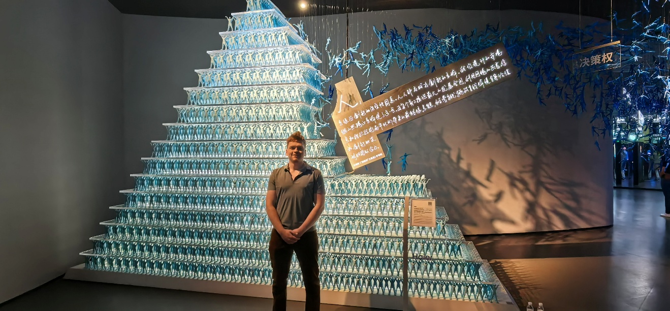 A person standing in front of a pyramid of water bottles

AI-generated content may be incorrect.