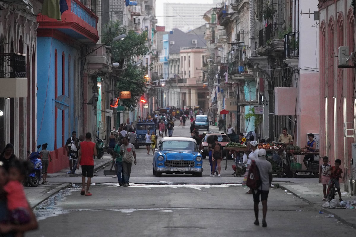 A street with people and cars
AI-generated content may be incorrect.