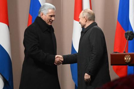 Two men shaking hands in front of flags
AI-generated content may be incorrect.
