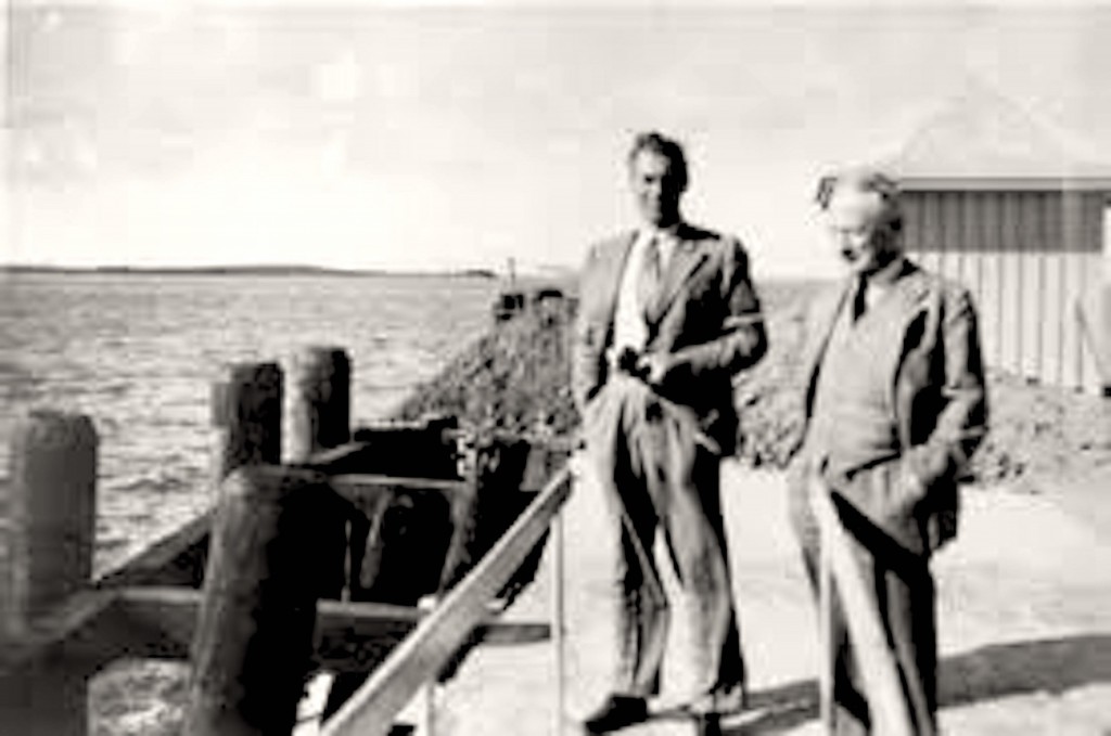 A couple of men standing on a dock AI-generated content may be incorrect.