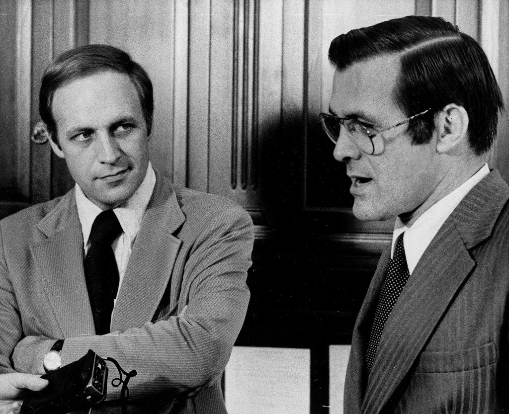 A person in a suit talking to another person

AI-generated content may be incorrect.