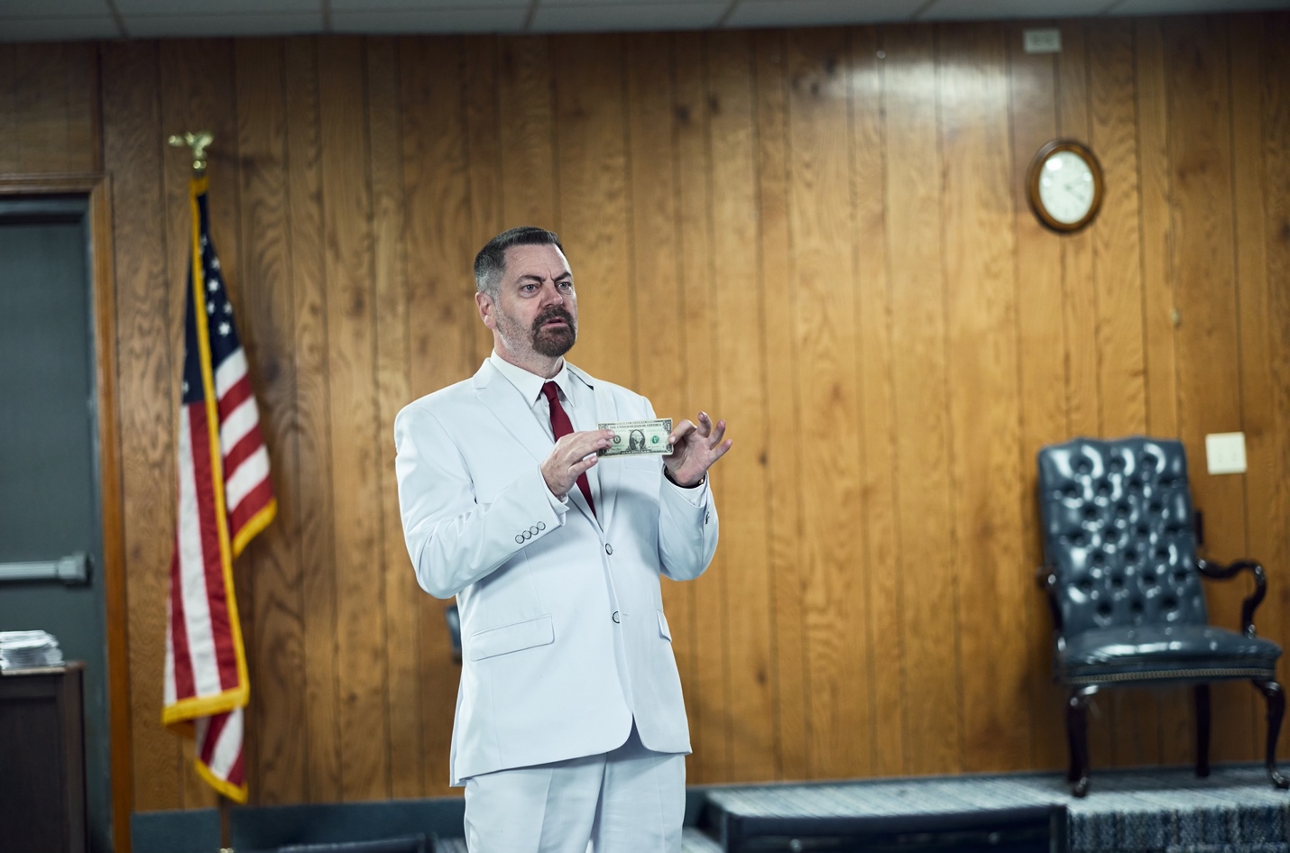 A person in a white suit holding a camera
AI-generated content may be incorrect.