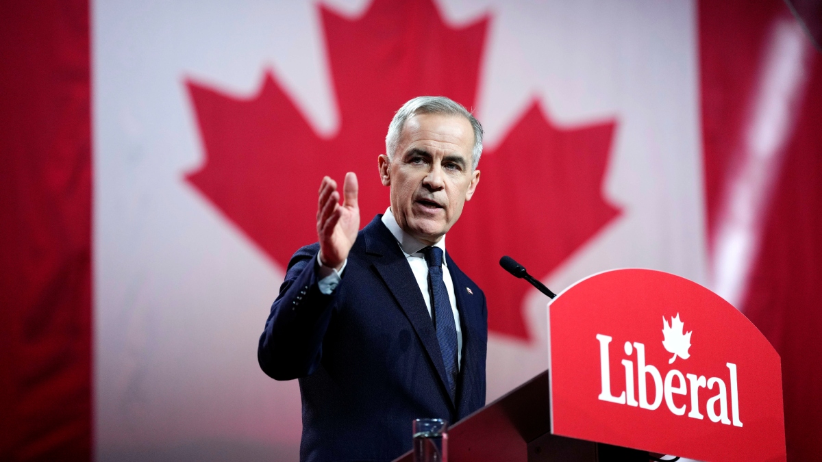 A person standing at a podium with a microphone and a flag behind him
AI-generated content may be incorrect.