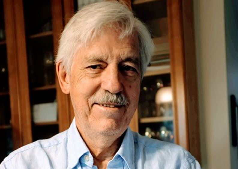A person with white hair and a mustache

AI-generated content may be incorrect.