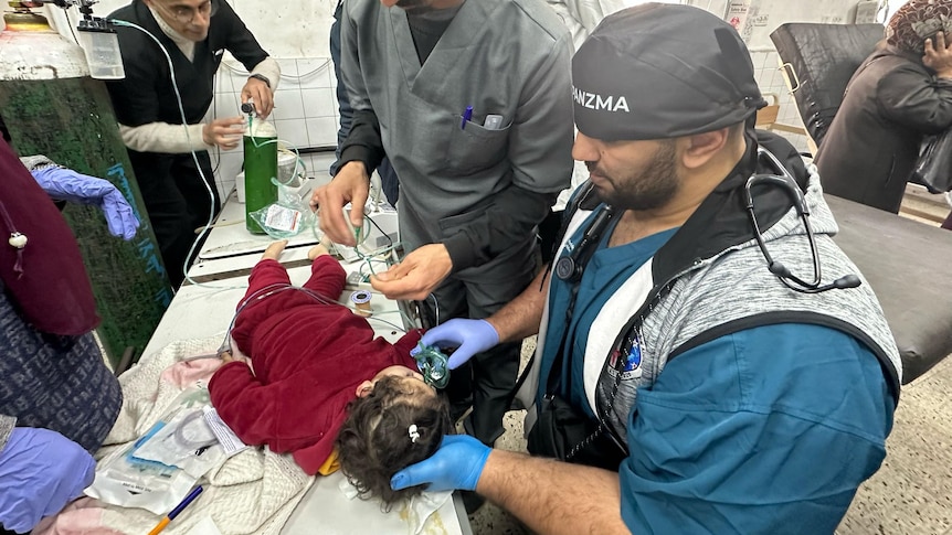 A photo of Dr Mo examining a child during one of his missions to Gaza. 