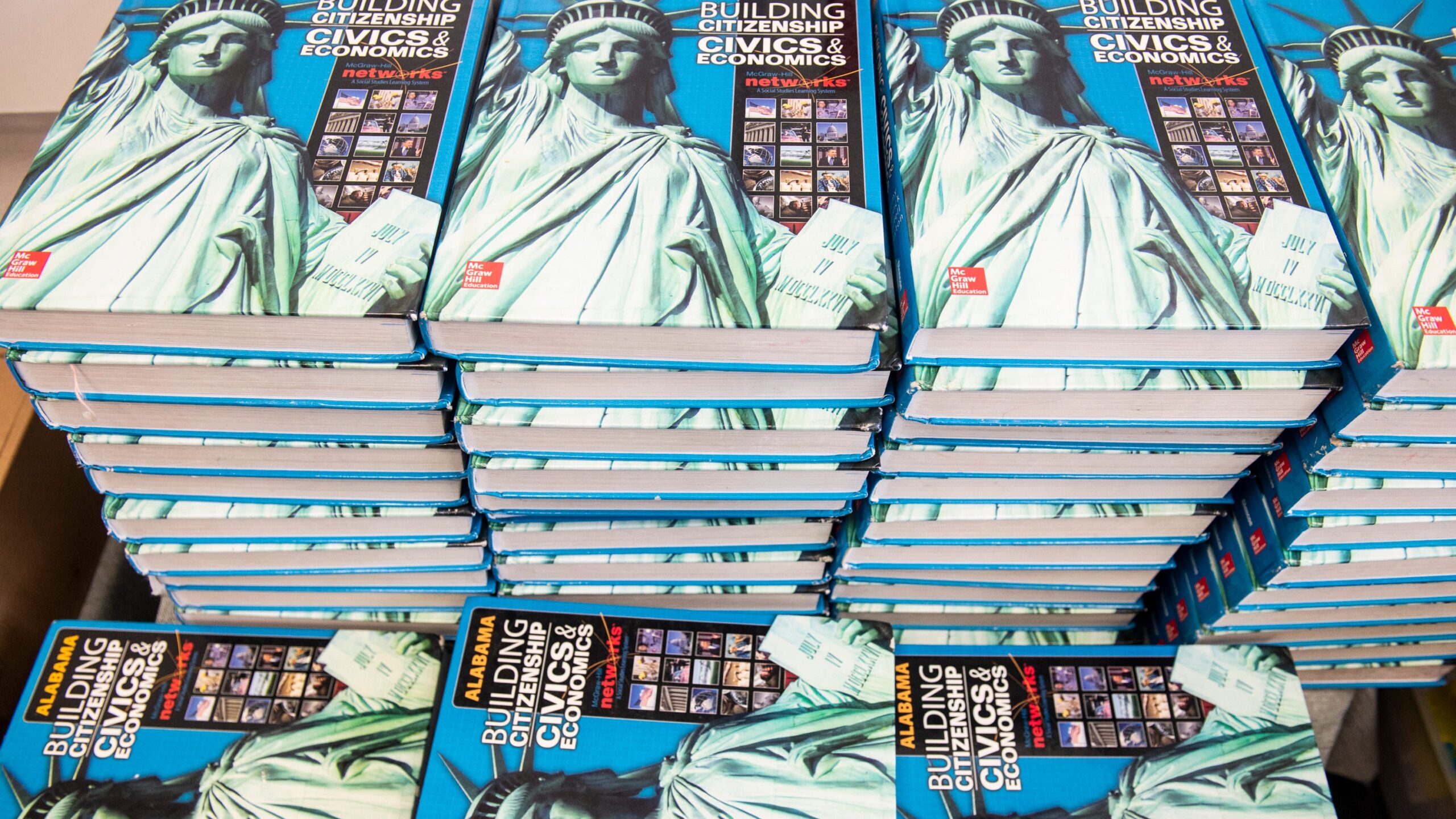 A stack of blue books
AI-generated content may be incorrect.