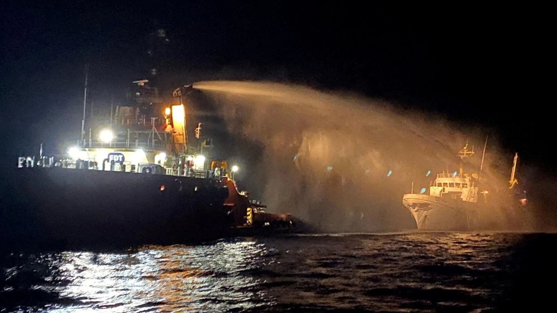 A tug vessel puts out a fire on the Gaza Freedom Flotilla vessel Conscience outside Maltese territorial waters in this handout picture provided by Malta Government Department of Information, 2 May 2025 (Government of Malta handout via Reuters)