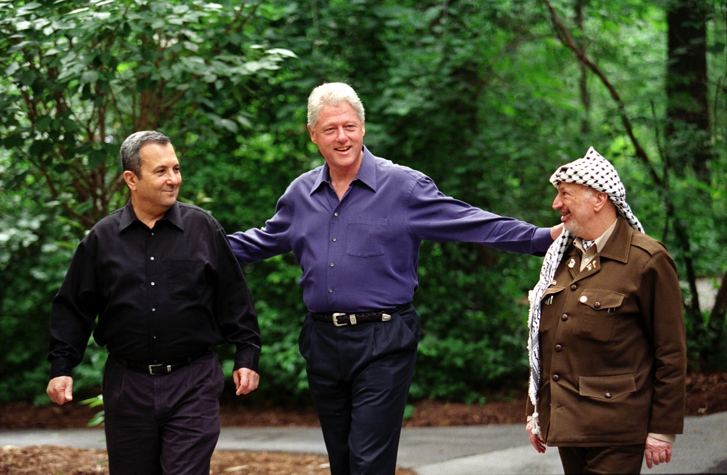 President Clinton walks the with Palestinian Authority Chairman Yasser Arafat and Prime Minister of Israel Ehud Barak at Camp David