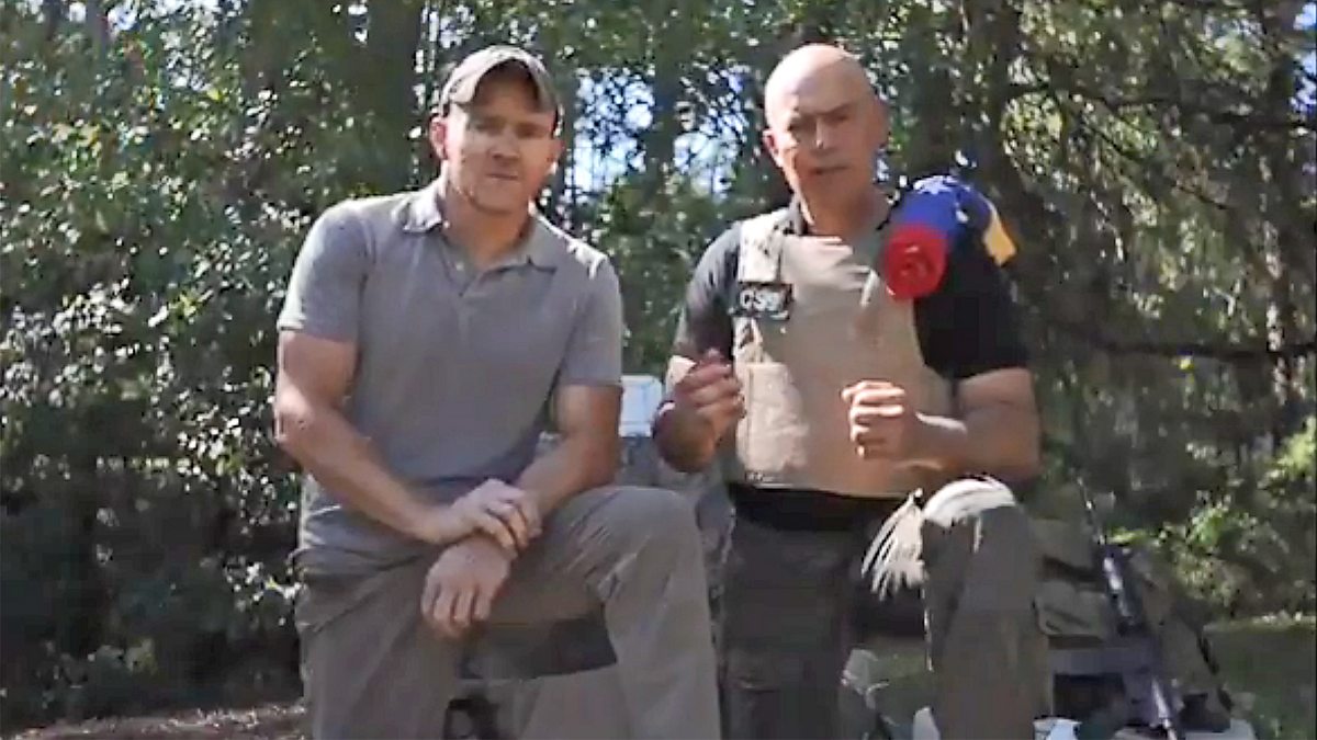 Two men standing next to each other
AI-generated content may be incorrect.