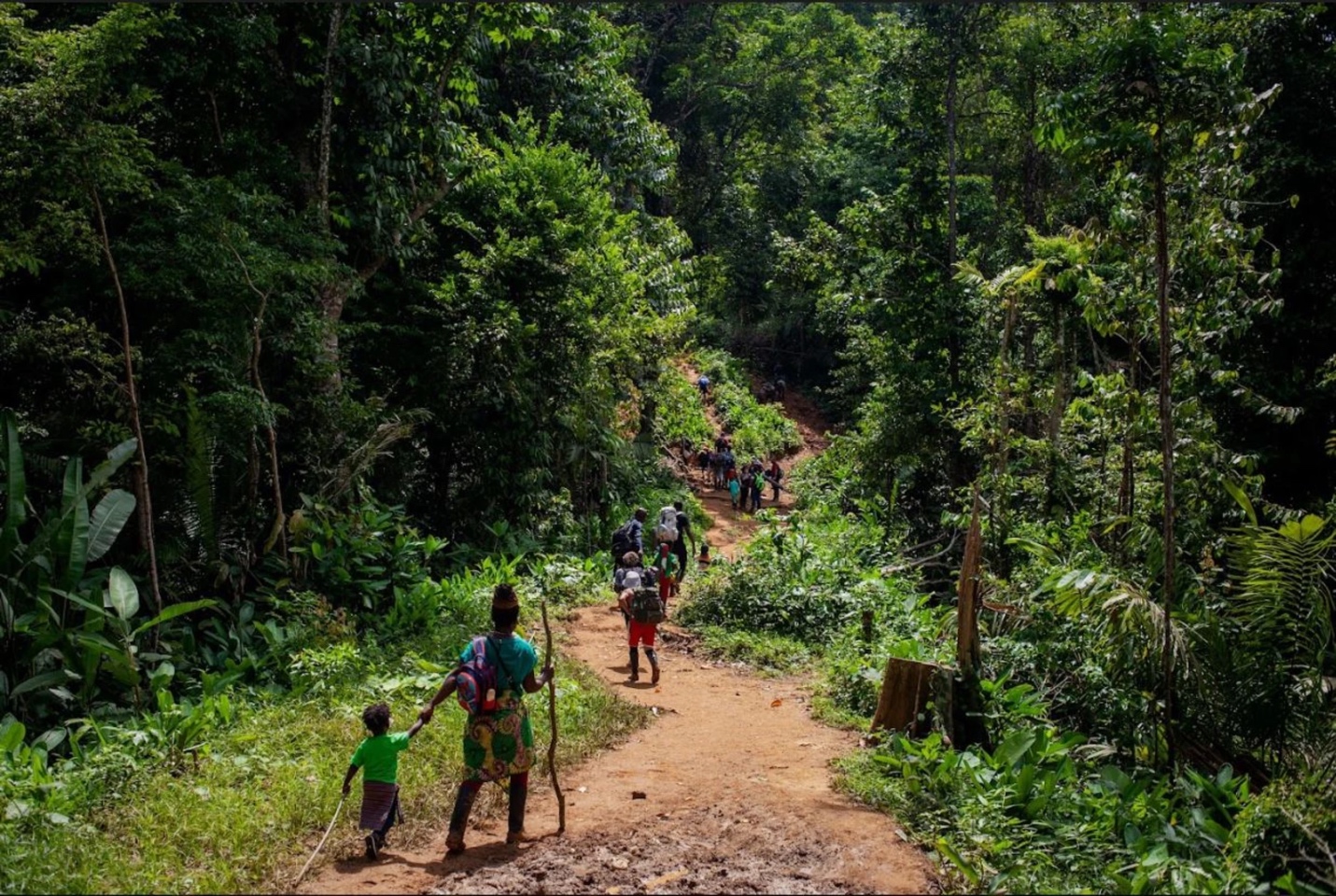 A group of people walking on a dirt path in the woods
AI-generated content may be incorrect.