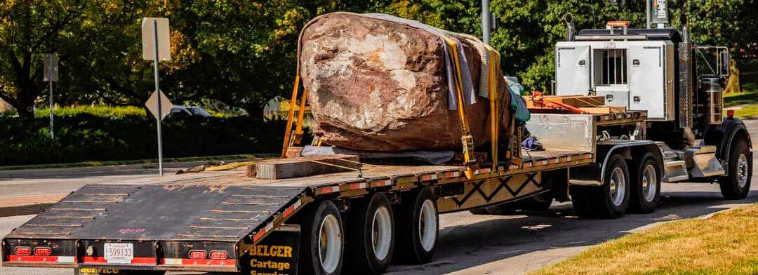 A large rock on a flatbed truck
AI-generated content may be incorrect.