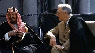 A person in a suit talking to a person
AI-generated content may be incorrect.