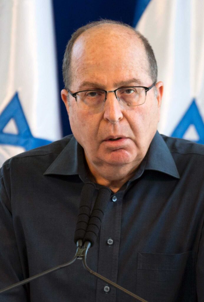 A person in glasses speaking into a microphone
AI-generated content may be incorrect.