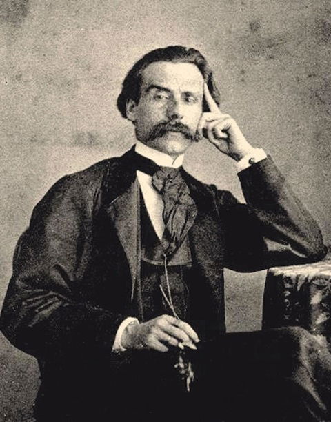 A person with a mustache holding his finger to his head

AI-generated content may be incorrect.