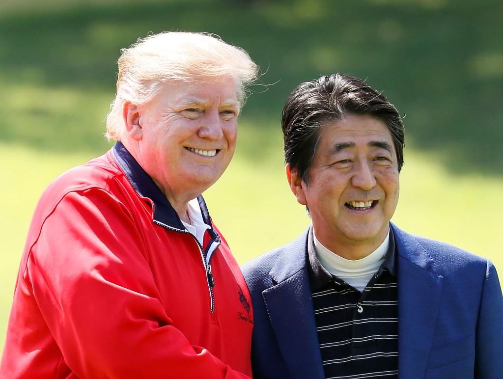 U.S. President Donald Trump and Japanese Prime Minister Shinzo Abe smile for a photo.