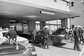 A group of people standing outside a building

AI-generated content may be incorrect.