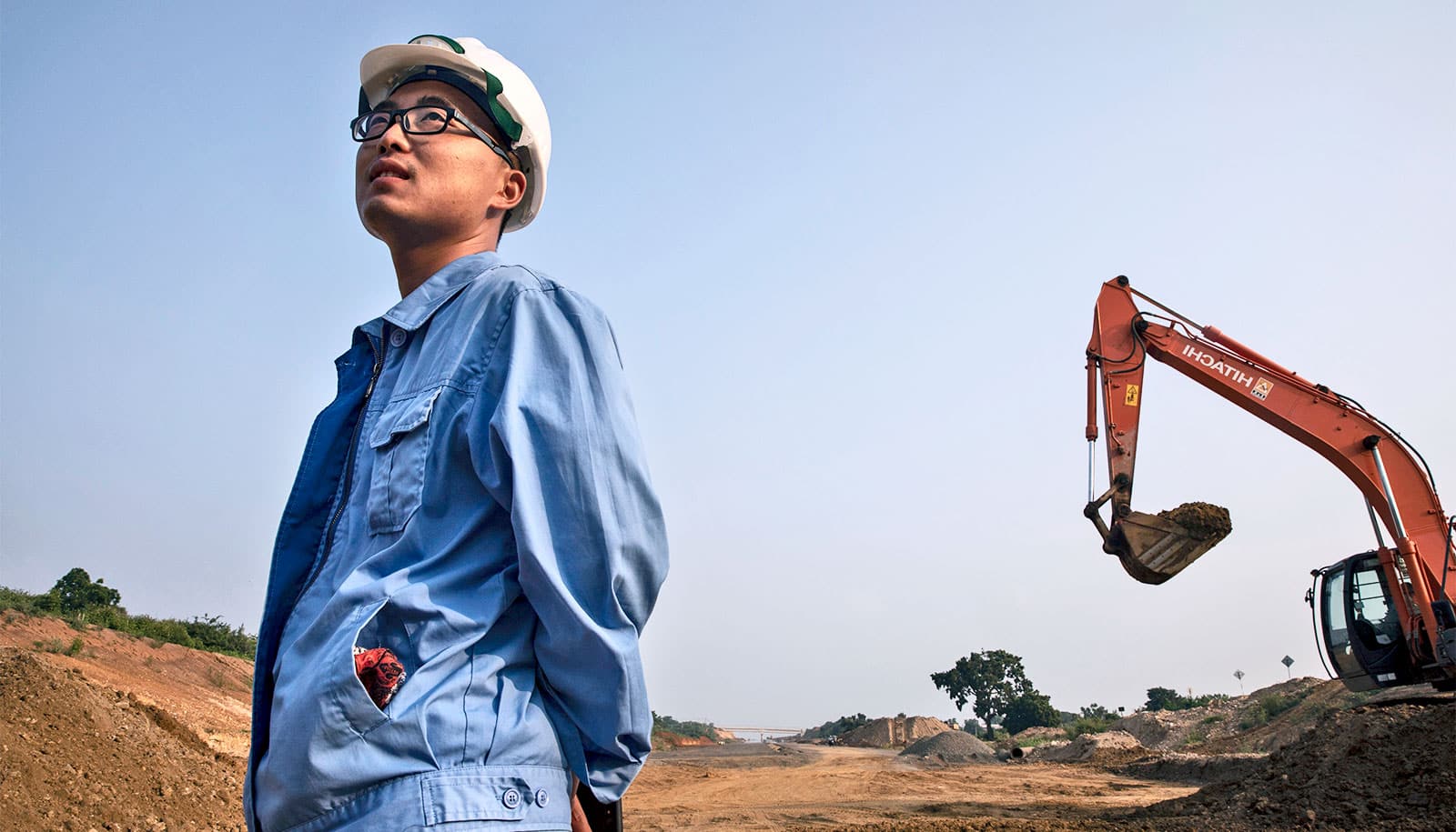 A person in a hard hat looking up at a crane

AI-generated content may be incorrect.