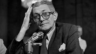 A person in a suit and tie

AI-generated content may be incorrect.