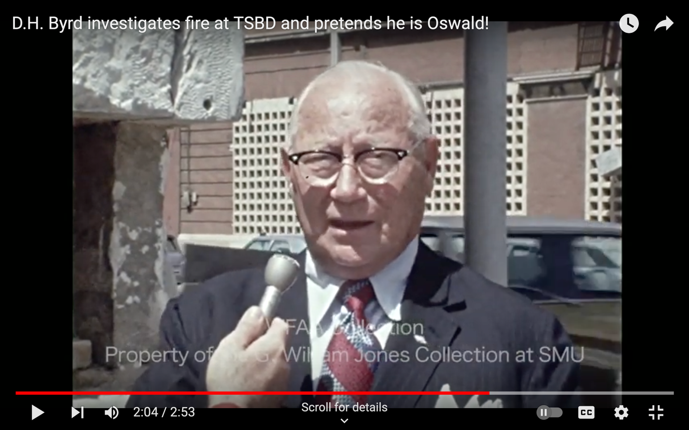 A person in a suit holding a microphone<br><br>AI-generated content may be incorrect.