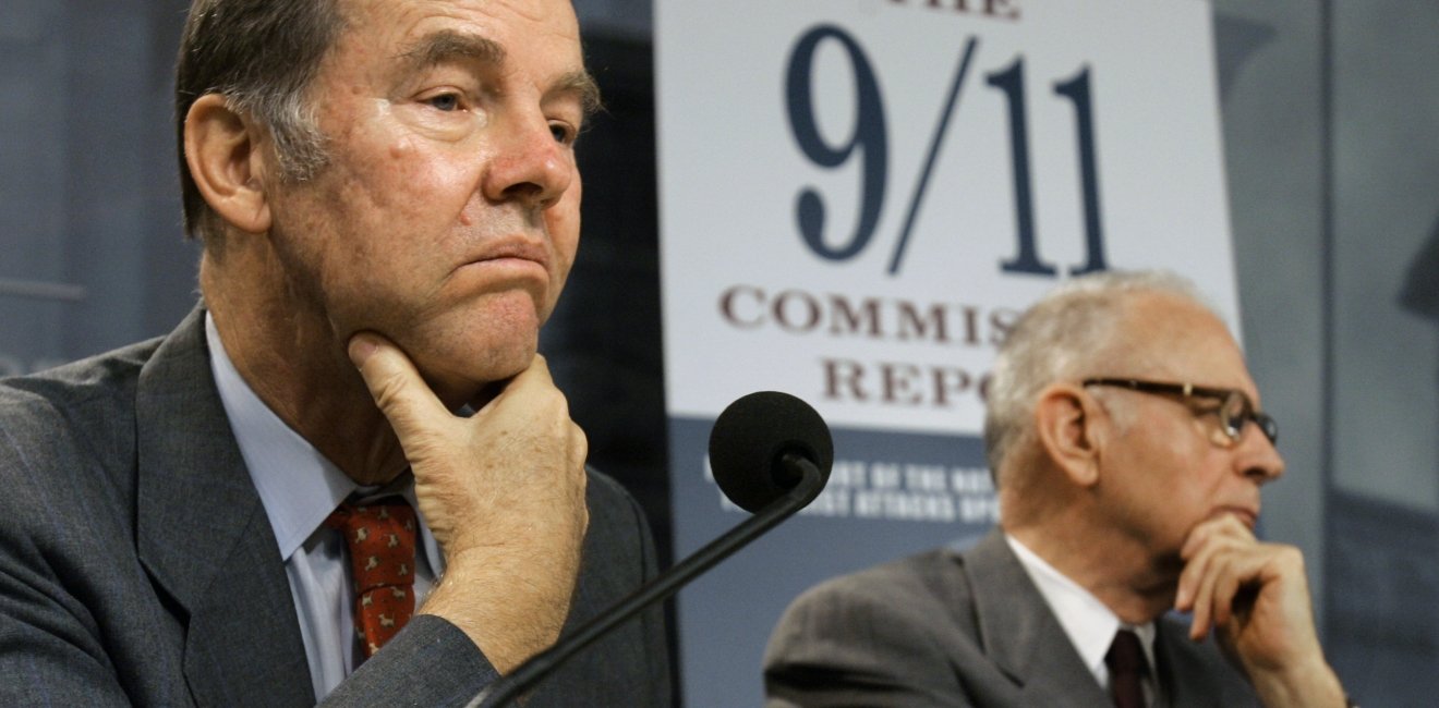 A person in a suit holding his chin
AI-generated content may be incorrect.