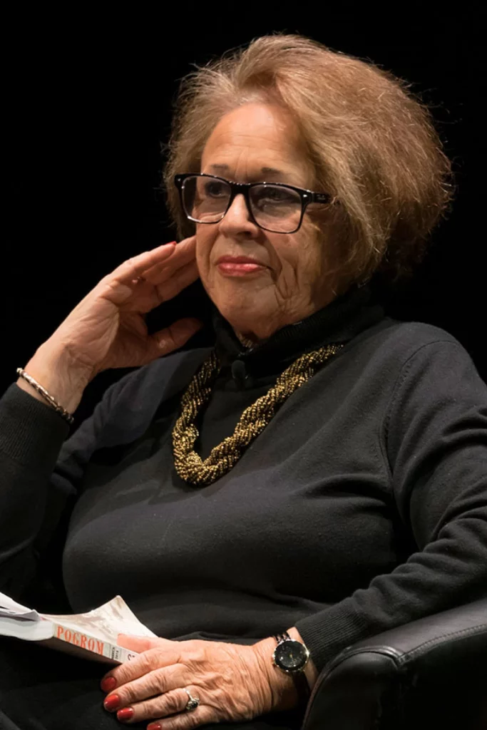 A person wearing glasses and a black sweater

AI-generated content may be incorrect.