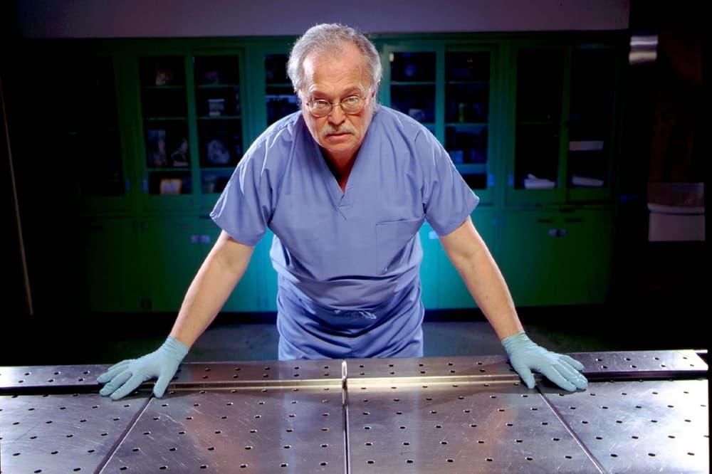 A person wearing gloves and scrubs standing at a table

AI-generated content may be incorrect.