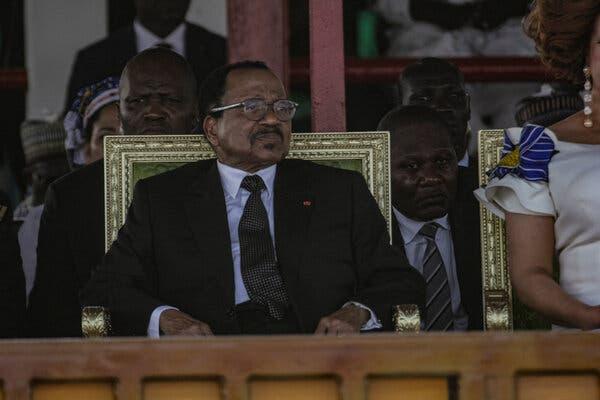 President Paul Biya of Cameroon, wearing a suit and sitting in a large gold chair. 