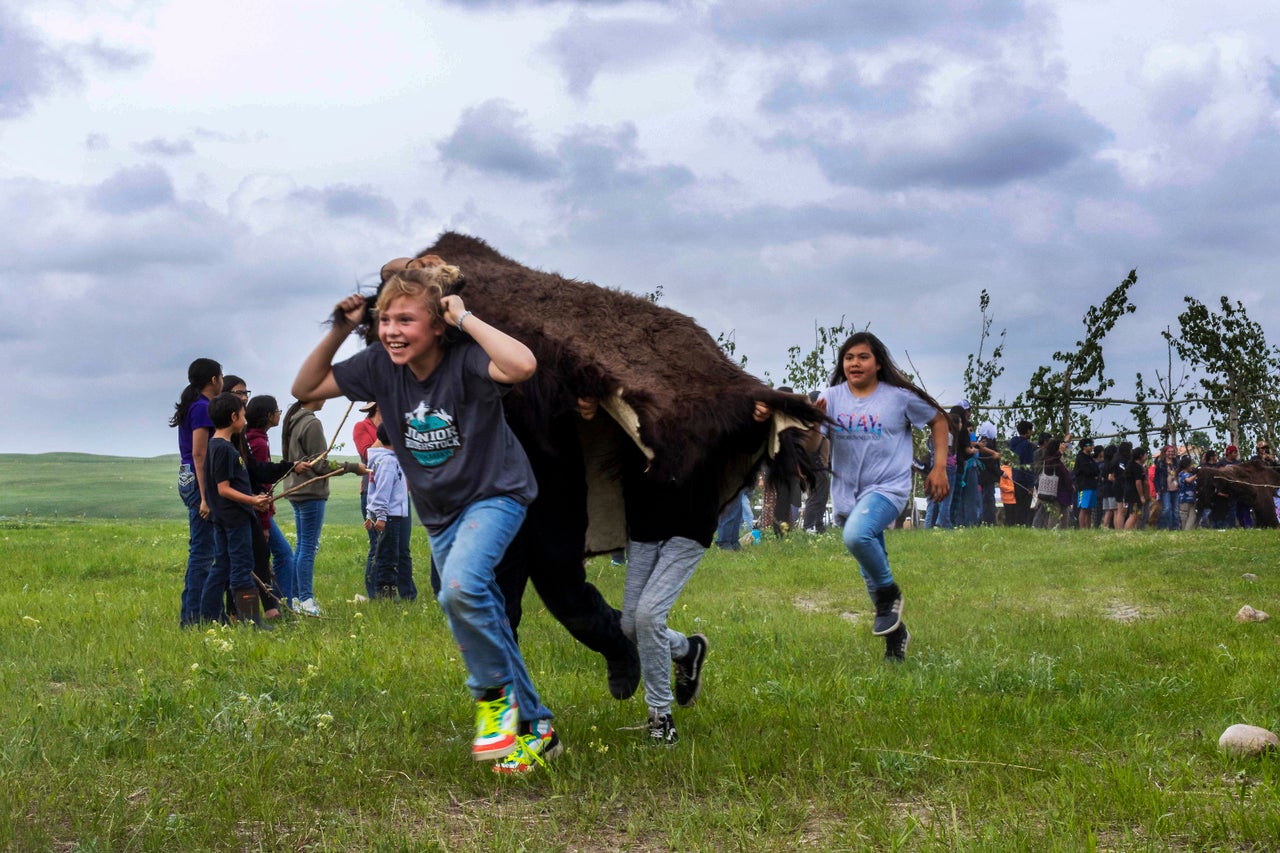 Young folks reenact a buffalo jump on June 2, 2023.