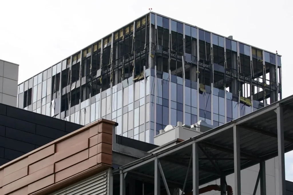 A building under construction with a few windows AI-generated content may be incorrect.