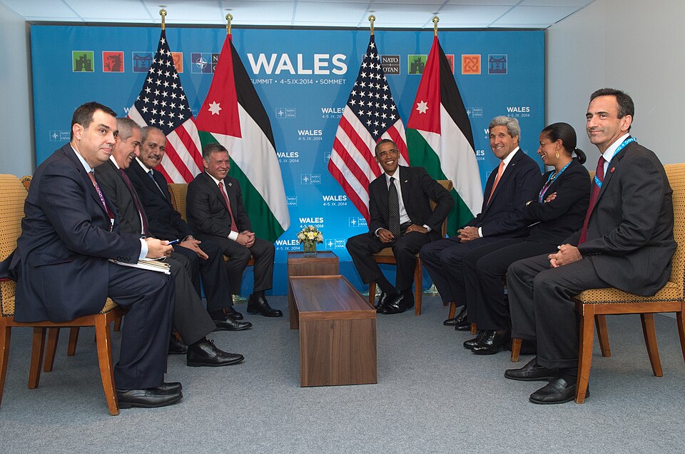 A group of men in suits sitting in a circle

AI-generated content may be incorrect.