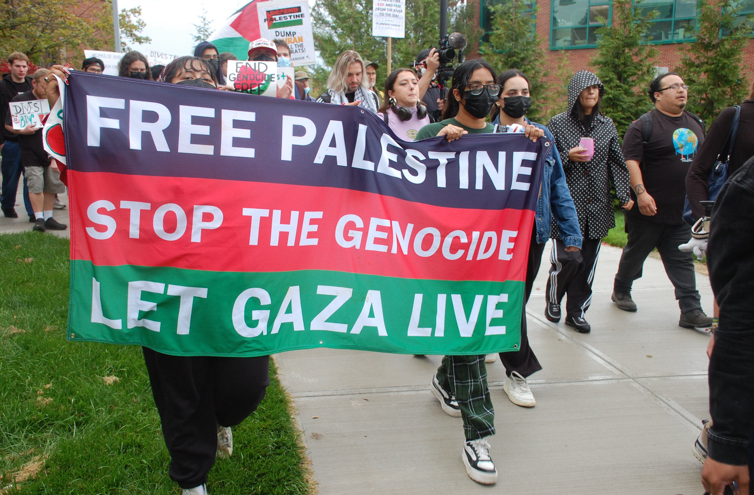 A group of people holding a banner

AI-generated content may be incorrect.