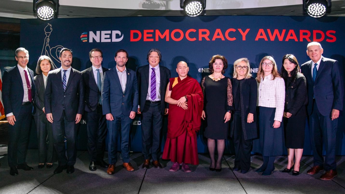 A group of people standing in front of a banner

AI-generated content may be incorrect.