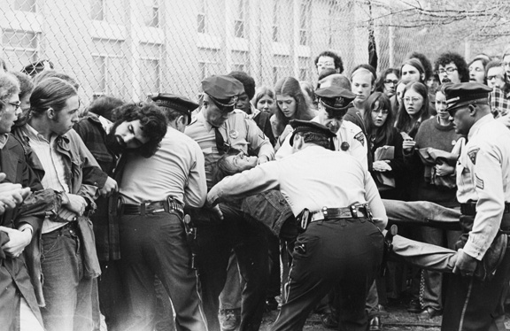 A group of police officers being carried by a person
AI-generated content may be incorrect.