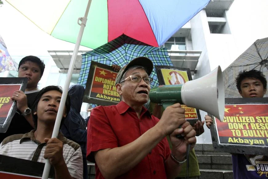 A person holding a megaphone and a person holding a sign
AI-generated content may be incorrect.
