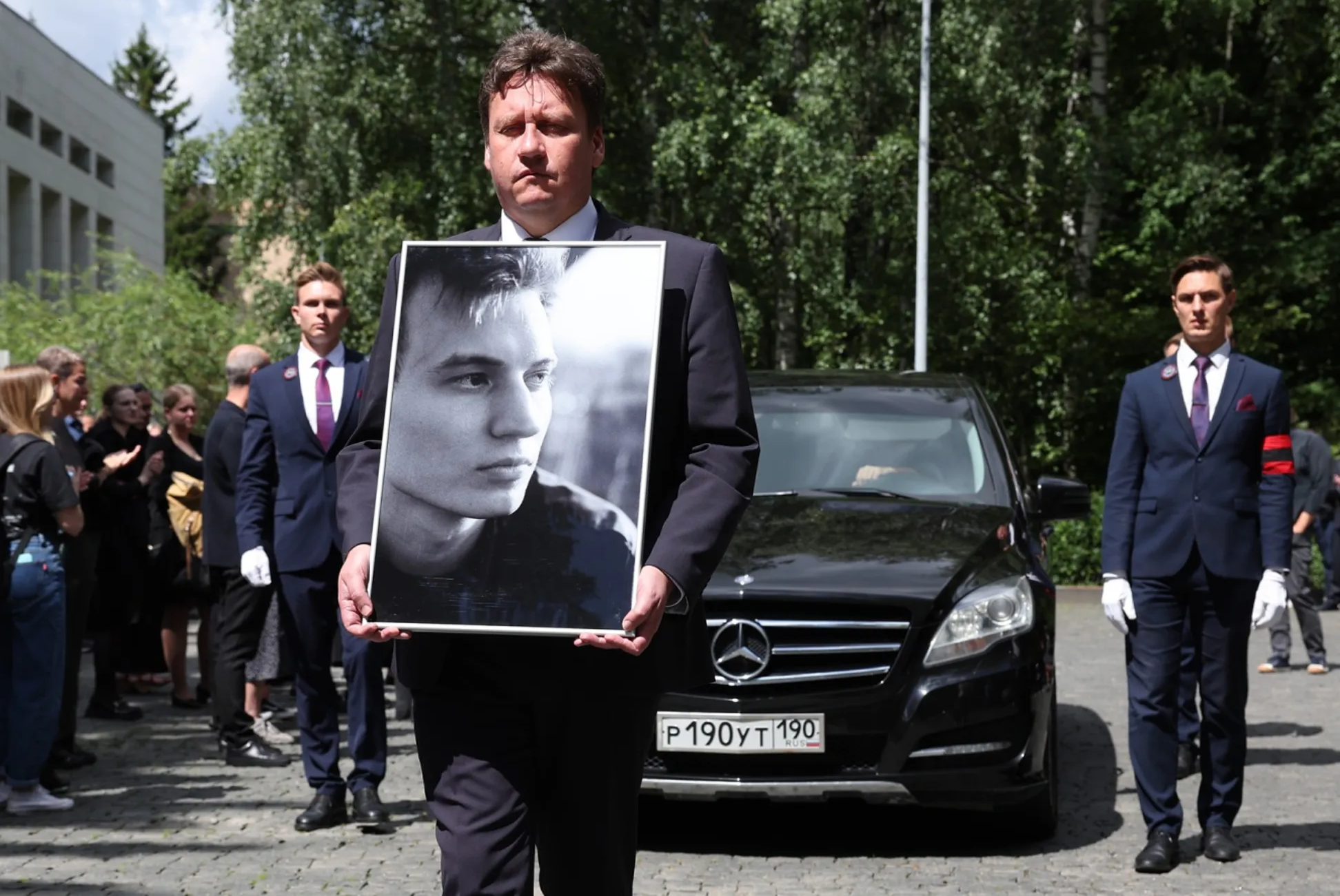 A person holding a picture of a person

AI-generated content may be incorrect.