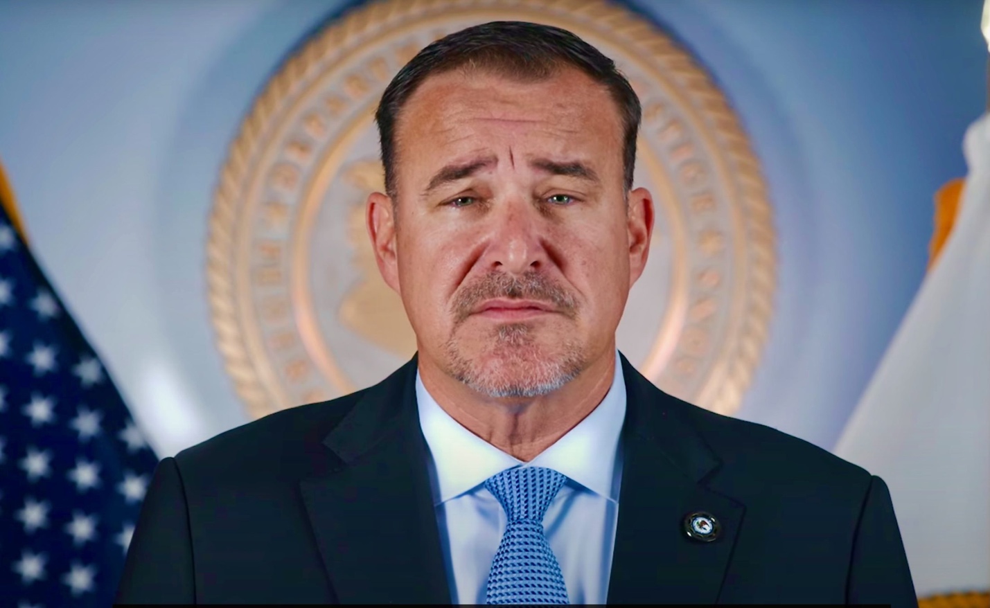 A person in a suit

AI-generated content may be incorrect.