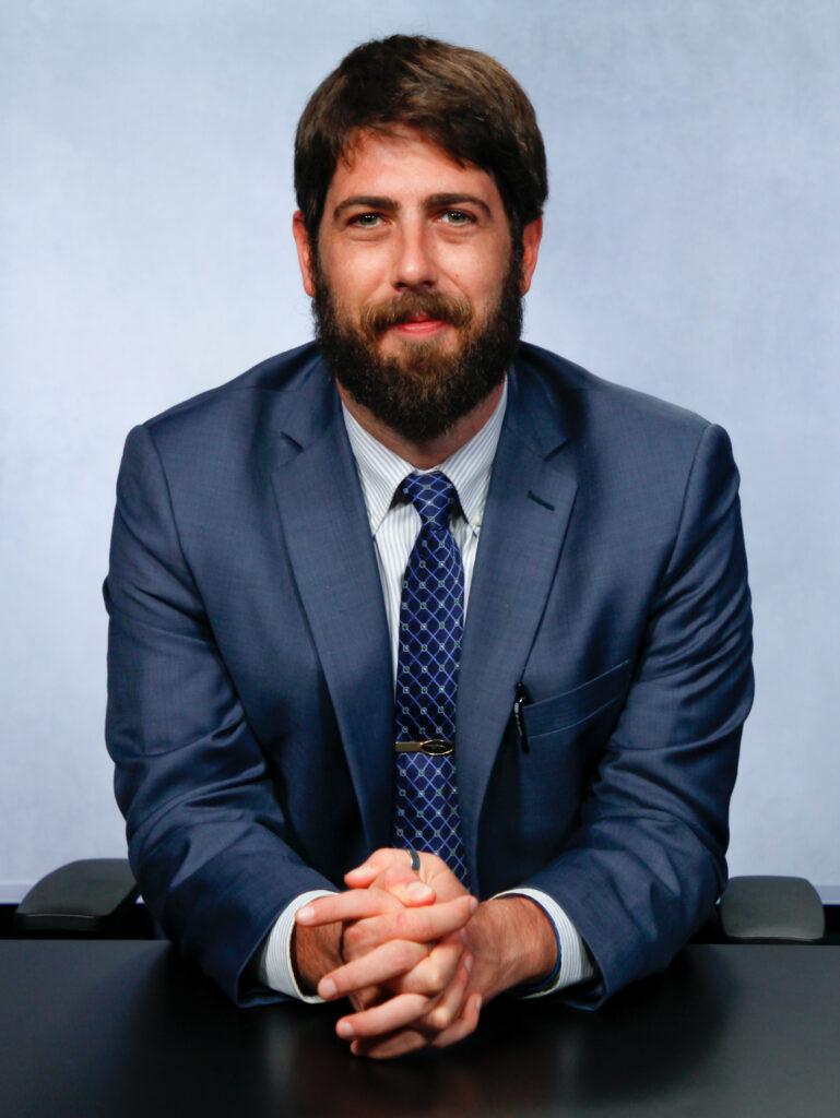 A person in a suit

AI-generated content may be incorrect.