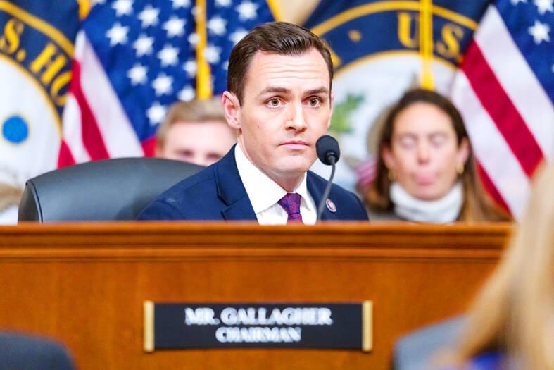 A person in a suit and tie at a podium with a microphone

AI-generated content may be incorrect.