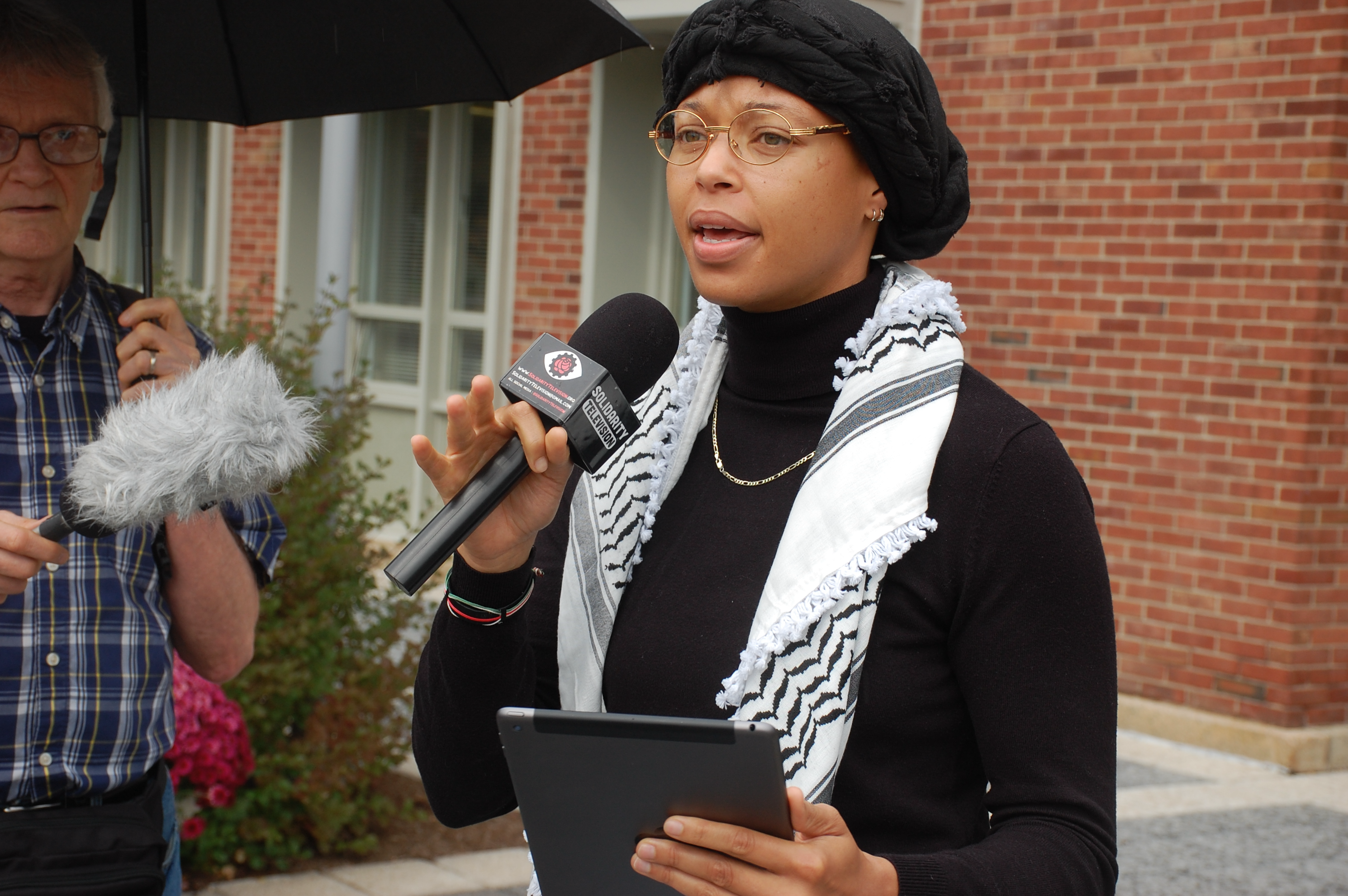 A person speaking into a microphone

AI-generated content may be incorrect.