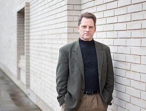 A person standing in front of a brick building

AI-generated content may be incorrect.