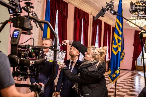 A TV camera rig can be seen in front of Volodymyr Zelensky on what appears to be a film set.