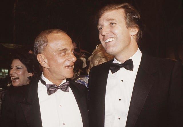 A couple of men in suits

AI-generated content may be incorrect.